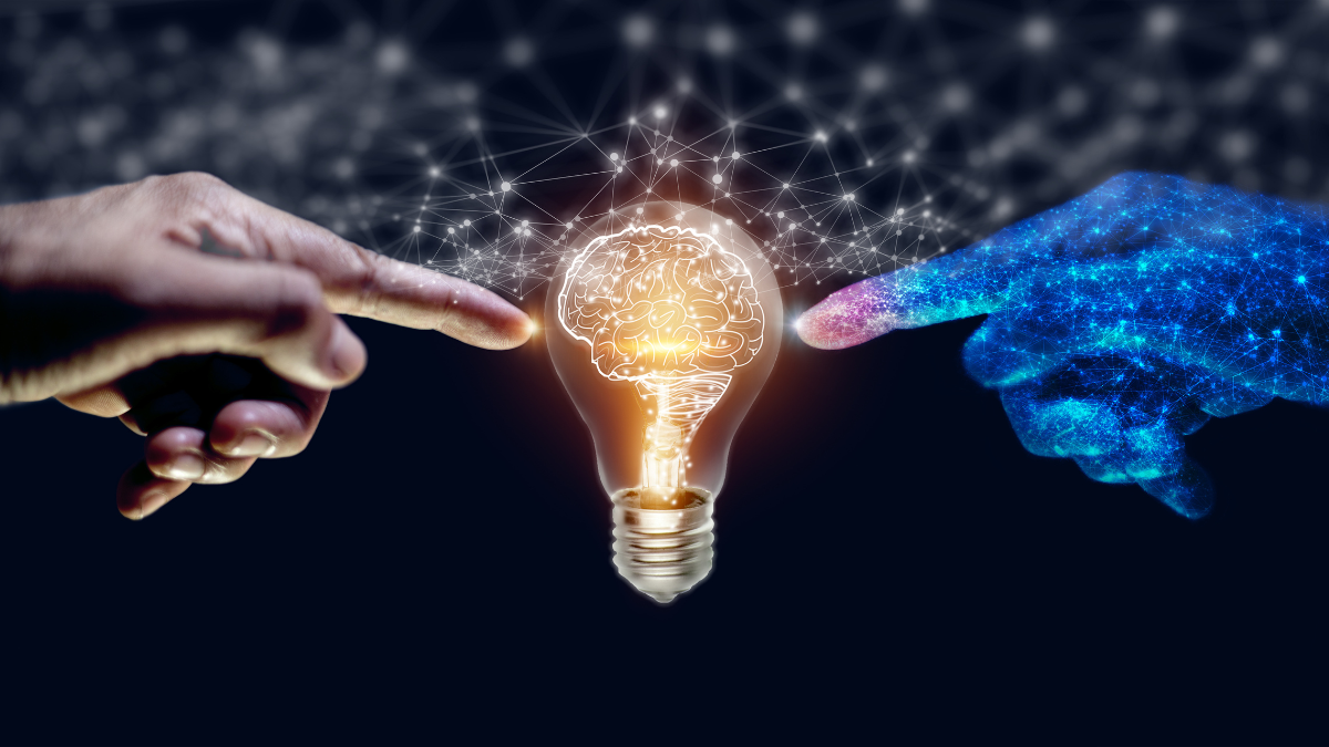 AI and Machine Learning - hands touching lightbulb
