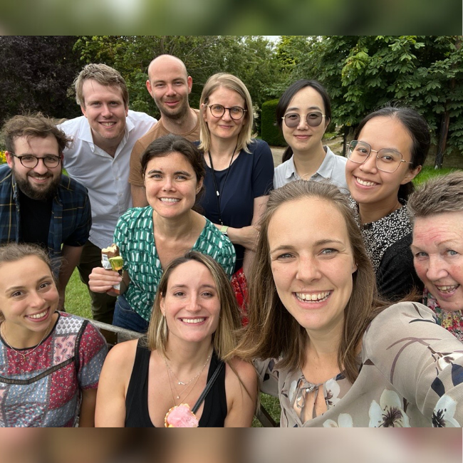 HydRegen team selfie. Ten people leaning in to take a selfie whilst holding ice creams. There is a green bush behind them.